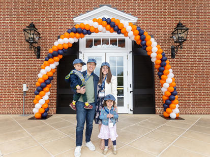 family in front of saunders hall